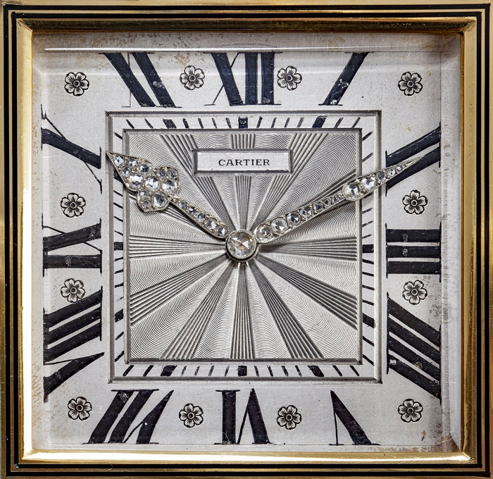 Roman numeral IIII on a Cartier desk clock dial.