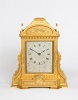 A lovely English engraved gilt brass table clock in the manner of Thoas Cole, by Manoah Rhodes, circa 1860.