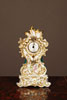 A porcelain French miniature Sappler timepiece by Jacob Petit, circa 1850.