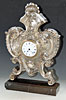 A silver neo-barock mantel clock. ca. 1900.